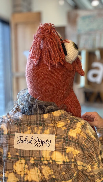 Person wearing a plaid shirt with &