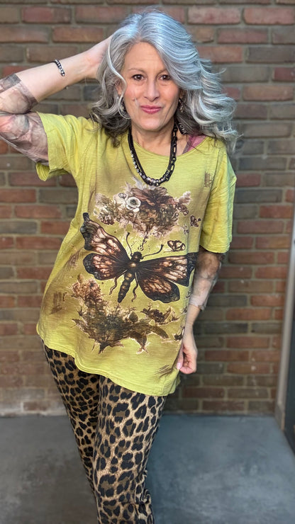 Woman wearing Moon Dance Tee - Evening Stop in front of a brick wall.