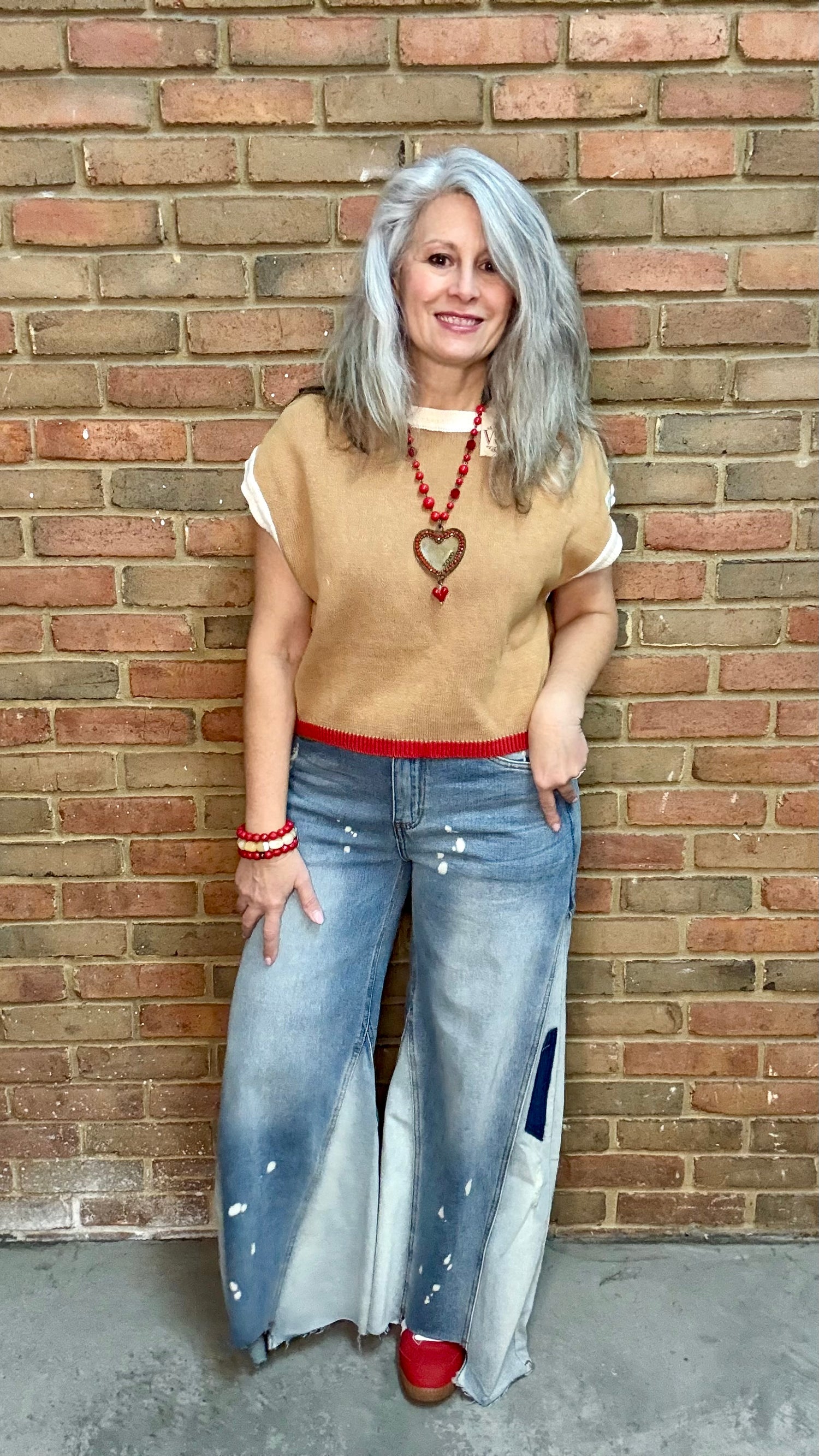 Woman wearing Chestnut Flame Sweater paired with Bleached Wide Leg Jeans and Heads Up - Red Shoes styled with XOXO heart on Red Bead Necklace