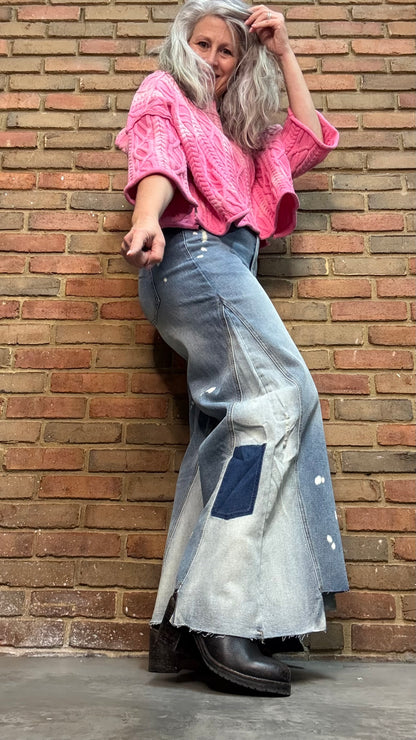 Woman wearing Bleached Wide Leg Jeans and Dusty Pink Ombre Sweater standing against a brick wall.
