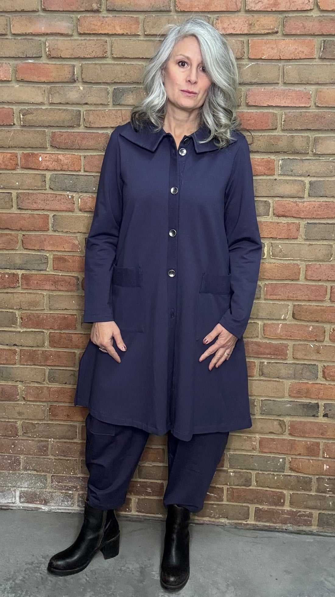 Woman wearing the matching Viola Jacket and Mady Pants in Plum