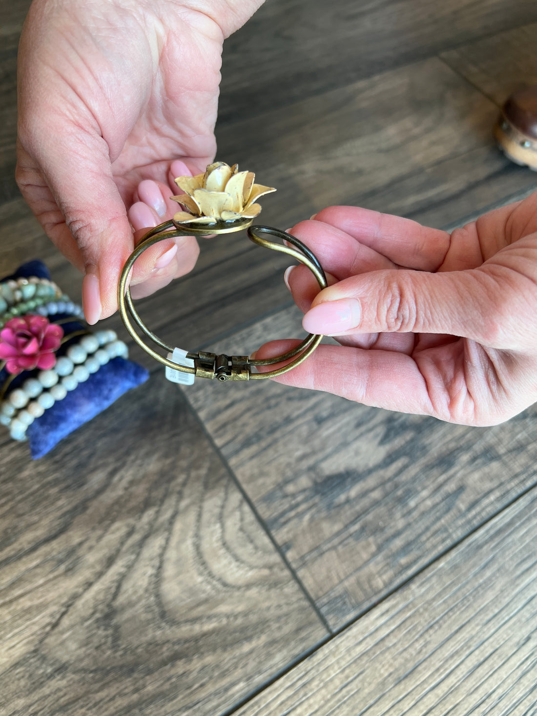 Flower Cuff on someones wrist with wood background.