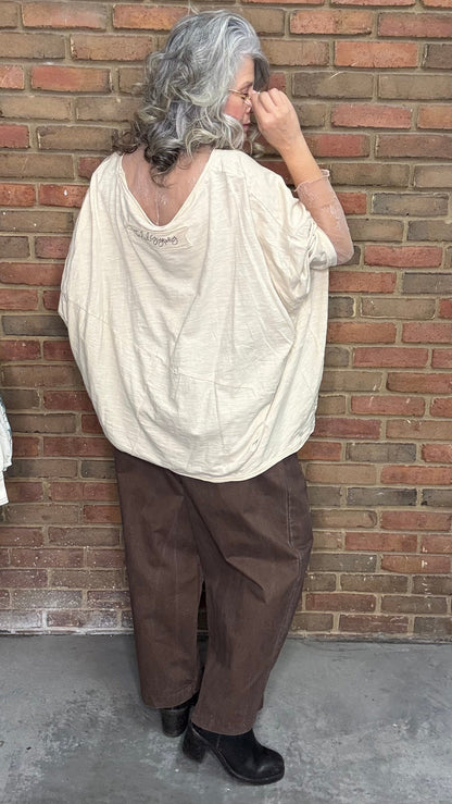 Person wearing the Be Free Growth Top and the Brown Pull On Pants against a brick wall.