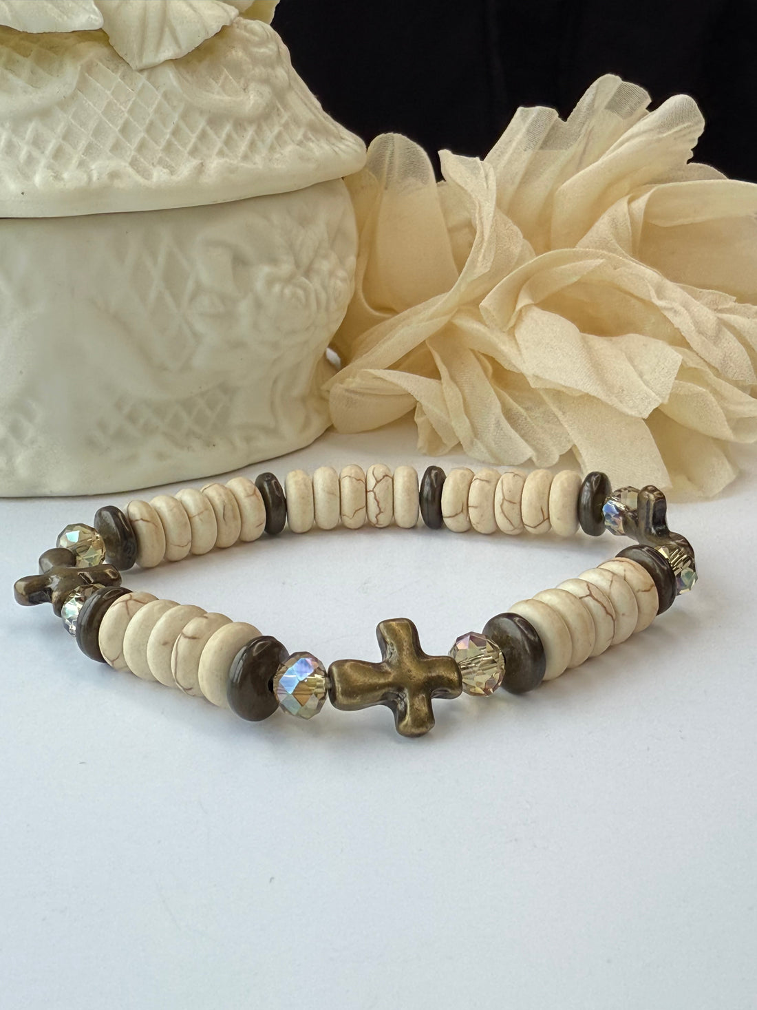 Bracelet with decorative beads and cross beads on a white background