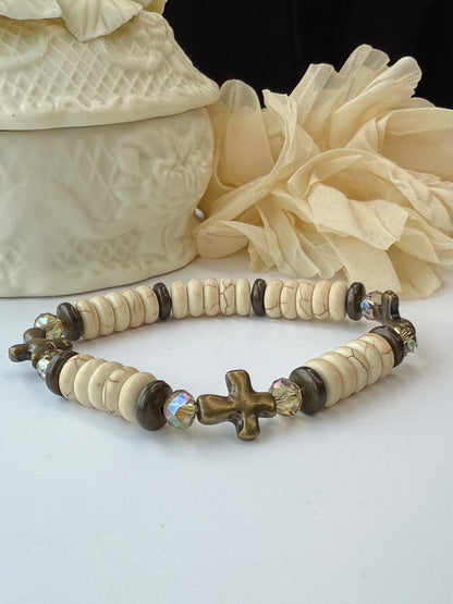 Bracelet with decorative beads and cross beads on a white background