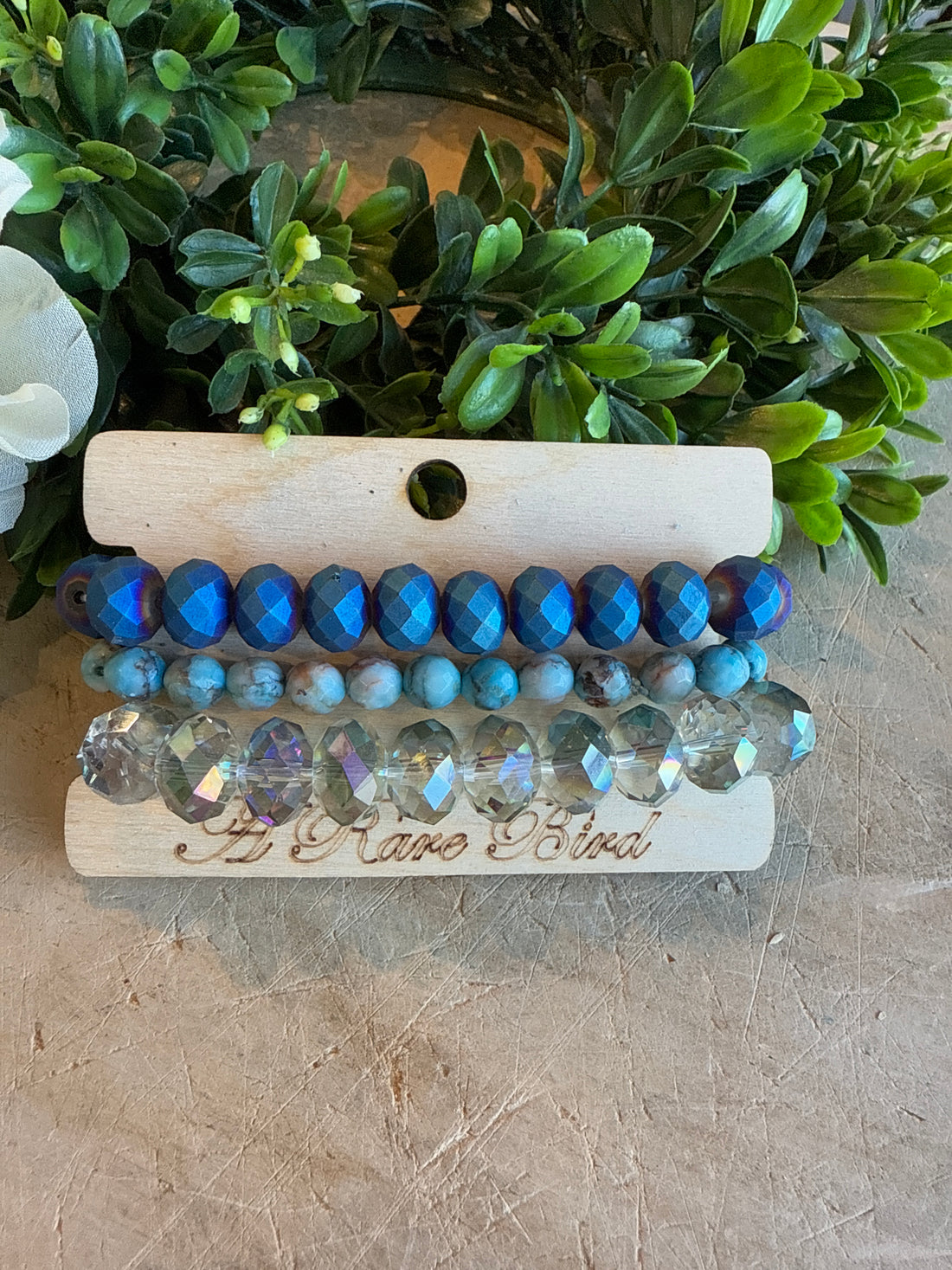 Crystal and Teal Stack Bracelets with greenery in the background