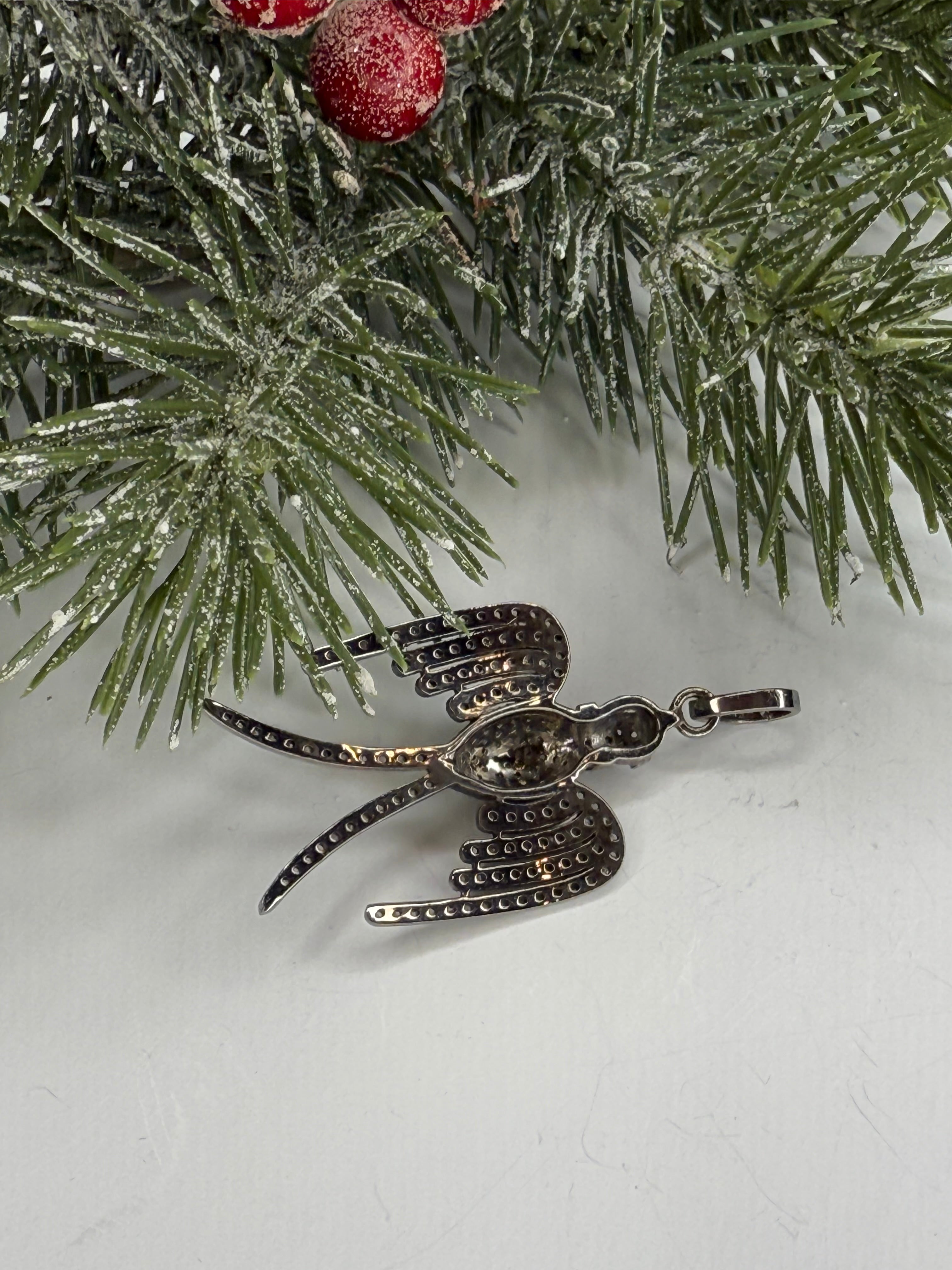 Back of bird shaped pendant showing holes for light.