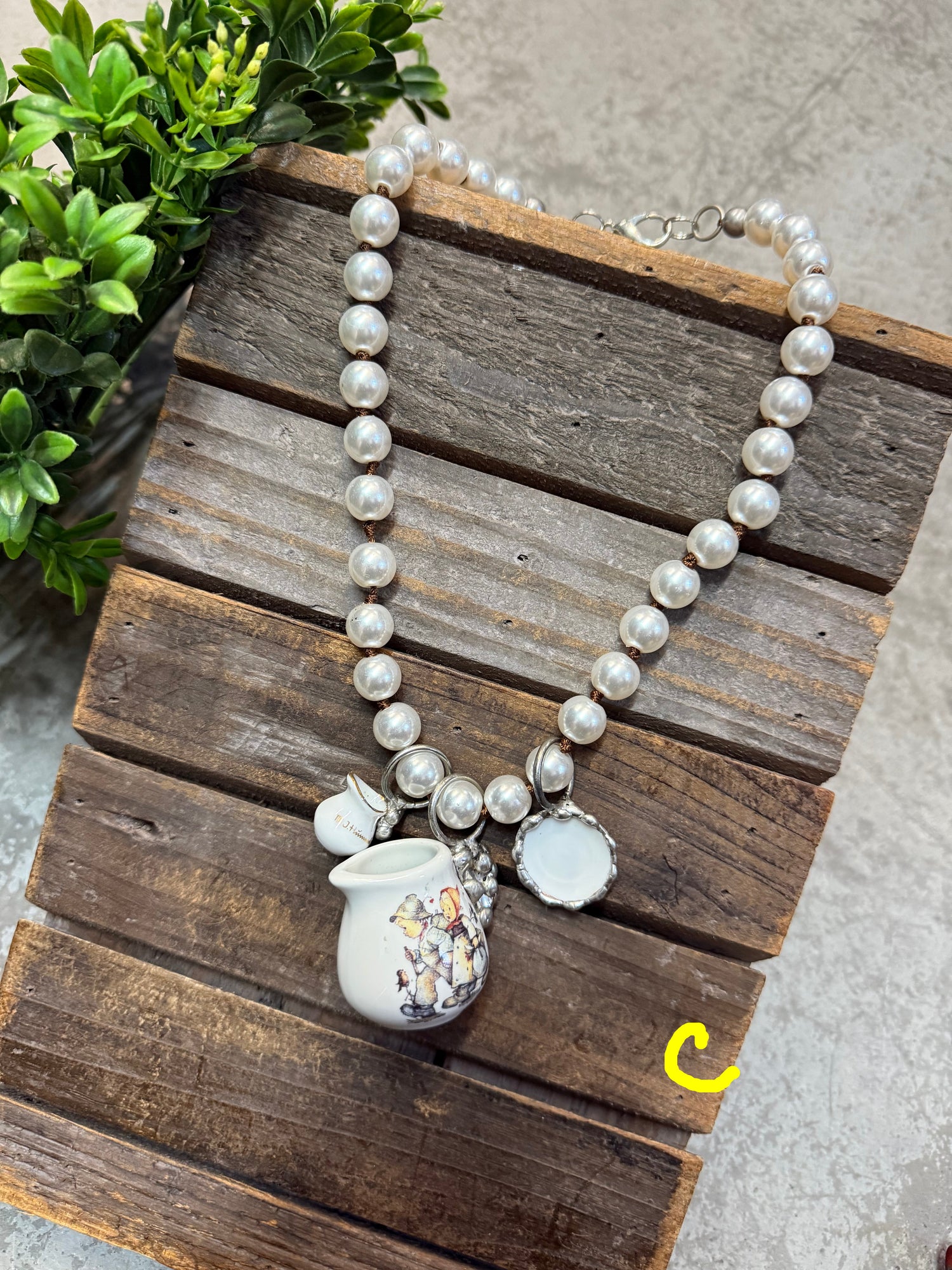 Pearl necklace with a silver clasp on a wooden surface