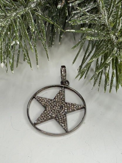Lone Star pendant with pave diamonds on a white surface with greenery