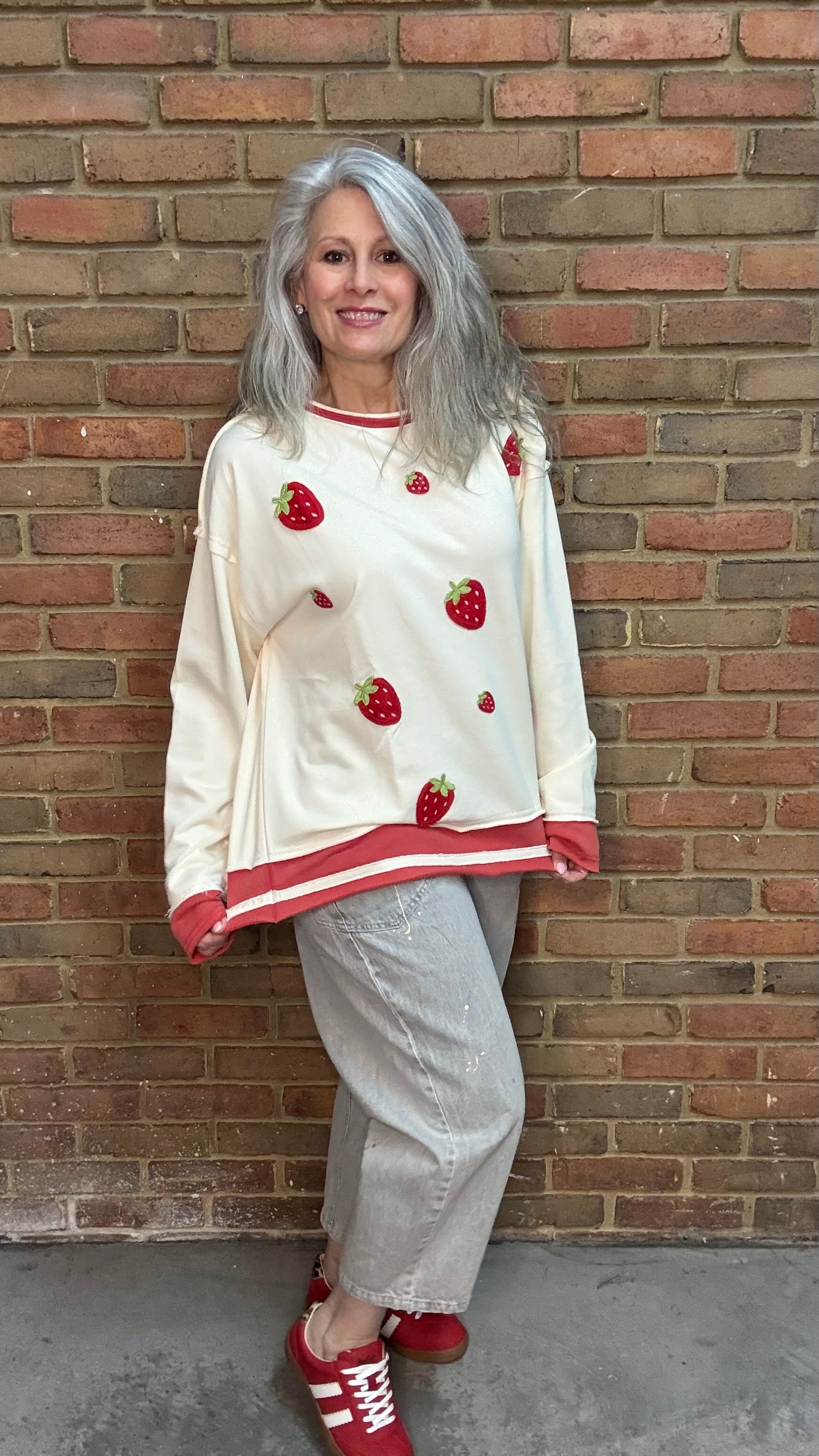 Woman wearing Strawberry Sweatshirt with Oyster Grey Big Pocket Jeans and Heads Up - Red Shoes