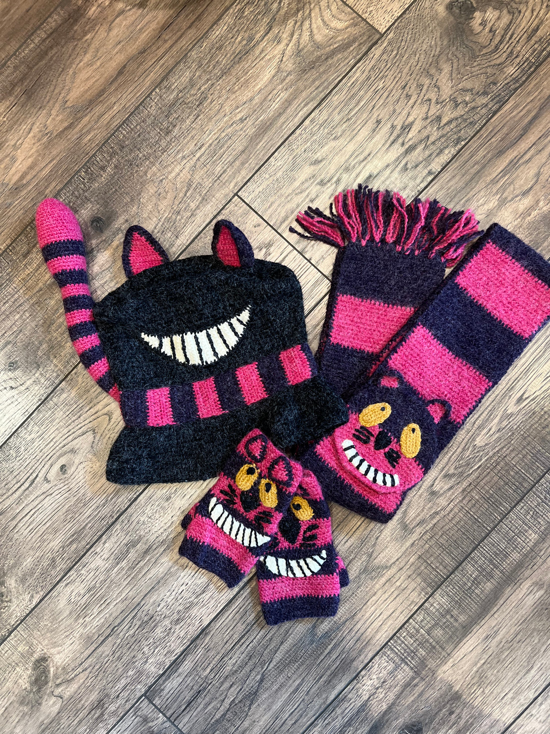 Striped scarf with cat design on a wooden floor