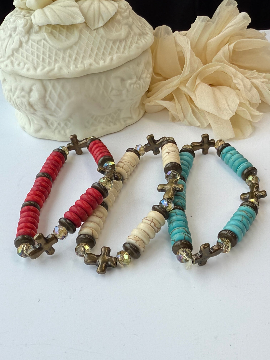 Bracelets with red, white, and turquoise beads on a white background