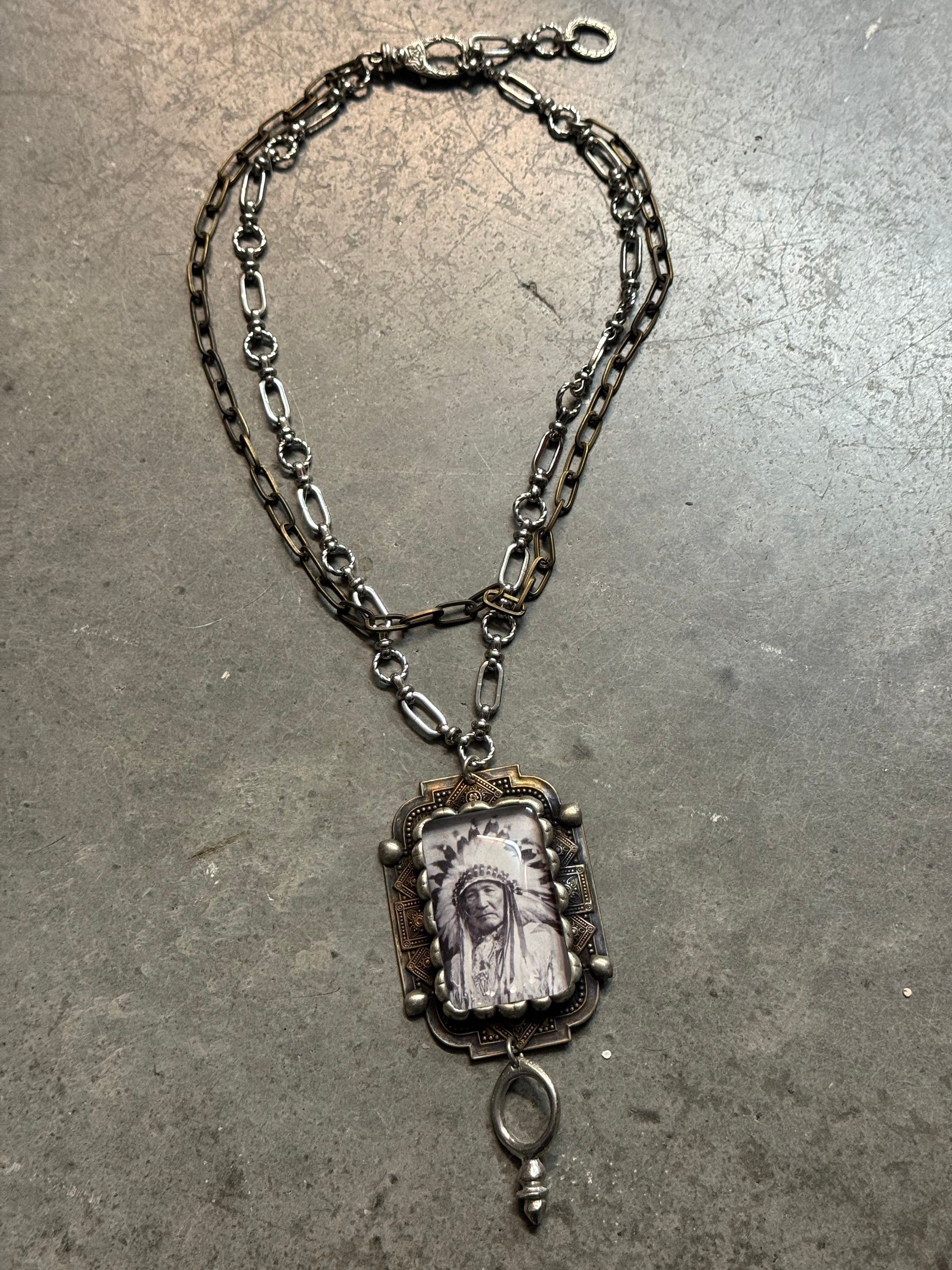 Silver chain bracelet with a decorative clasp on a gray surface