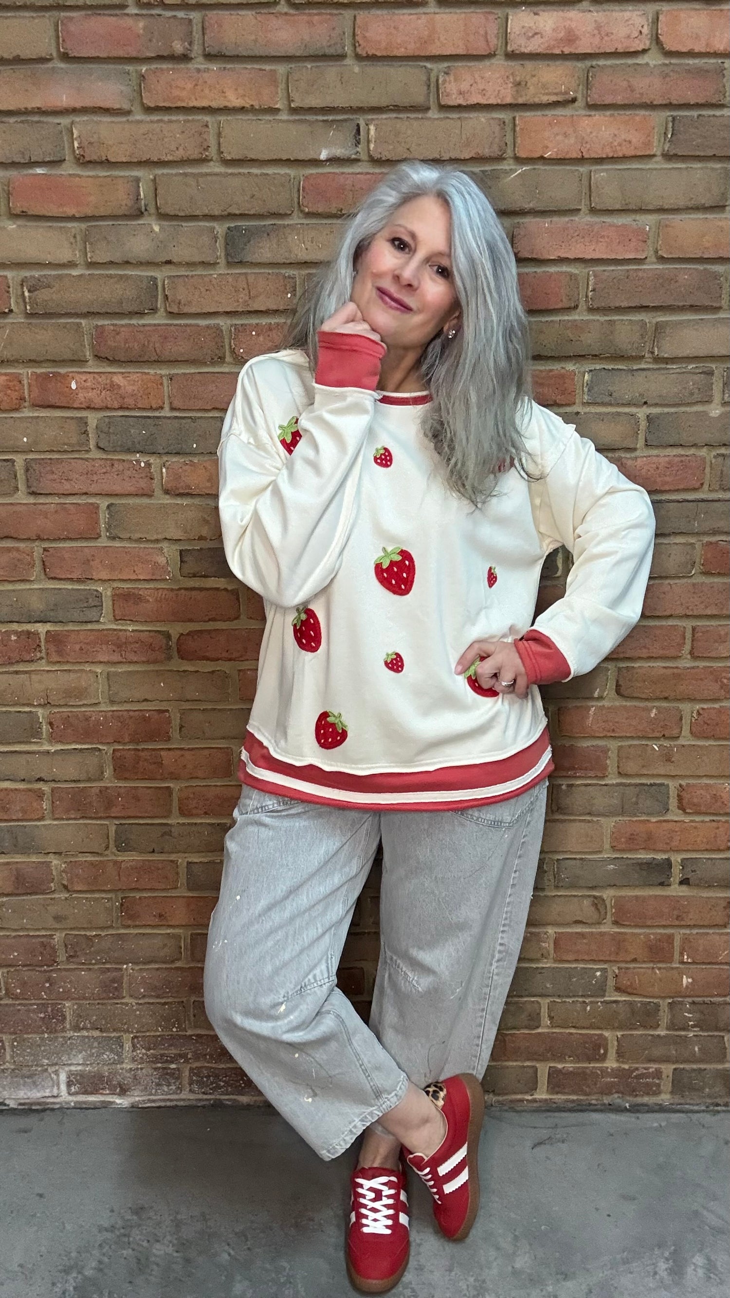 Woman wearing Strawberry Sweatshirt with Oyster Grey Big Pocket Jeans and Heads Up - Red Shoes