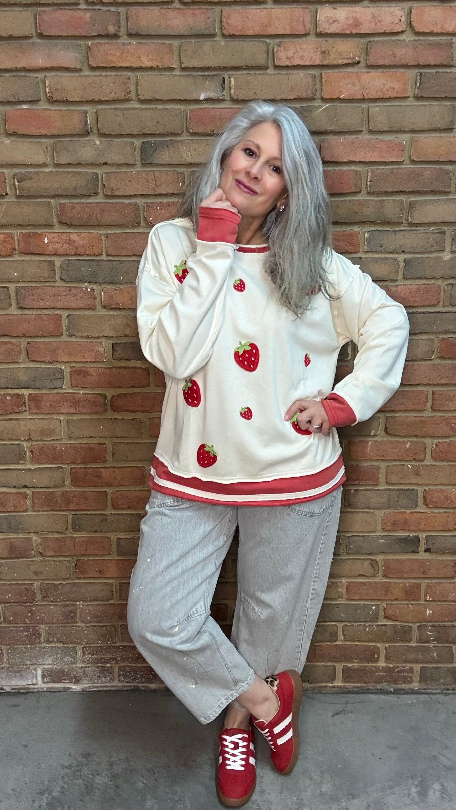 Woman wearing Strawberry Sweatshirt with Oyster Grey Big Pocket Jeans and Heads Up - Red Shoes