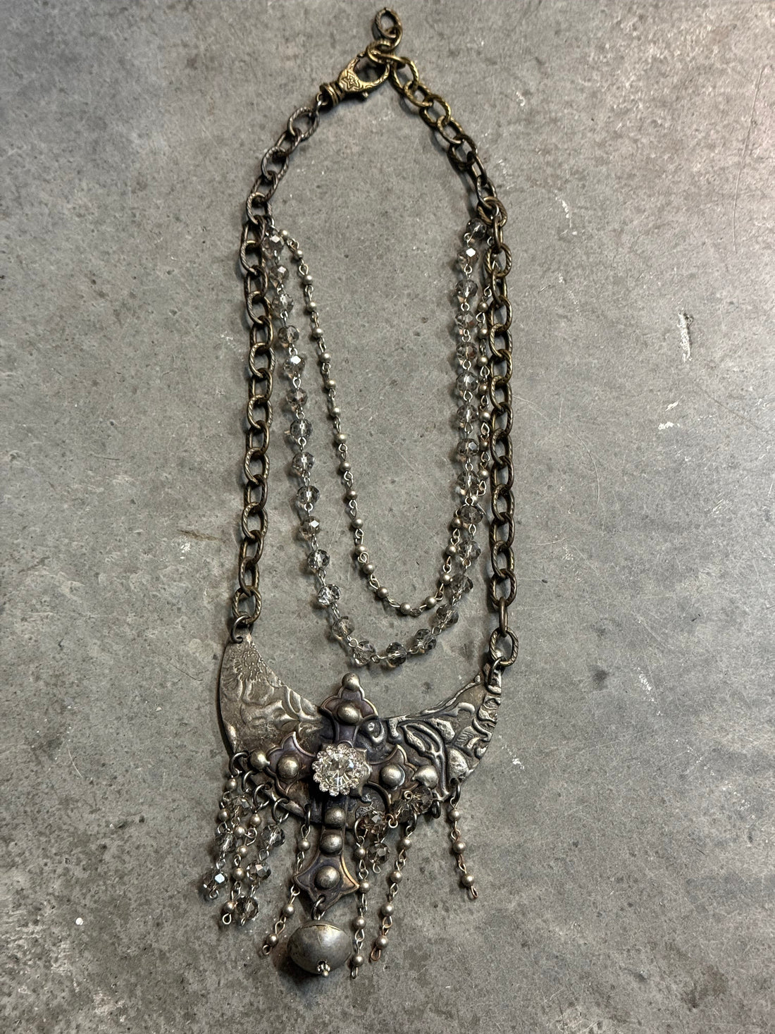 Vintage silver chain necklace on a concrete surface