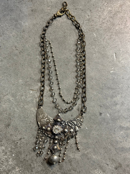 Vintage silver chain necklace on a concrete surface