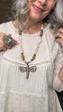 Woman wearing a Dragonfly Pendant on Pearl Necklace.