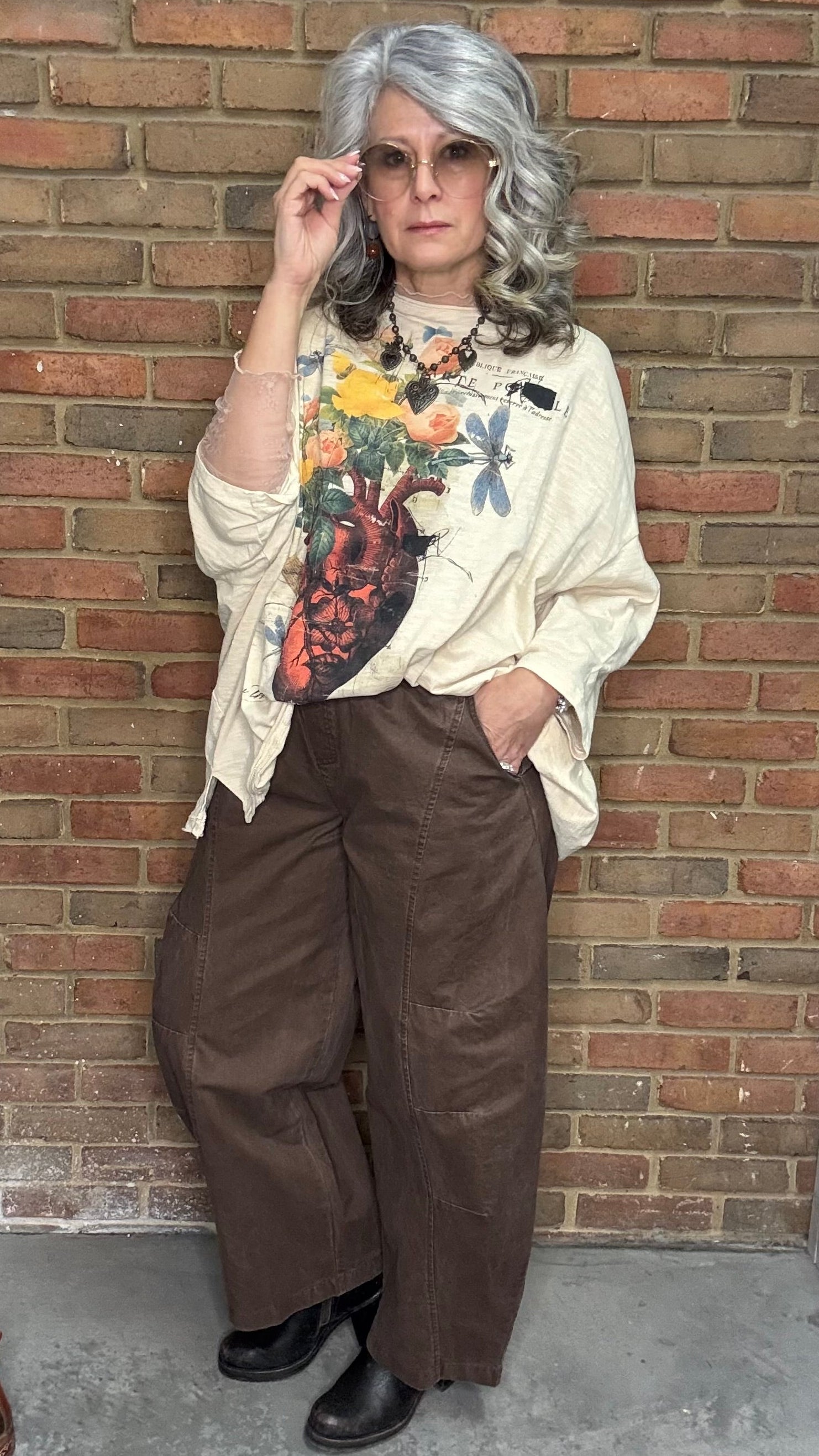 Person wearing a floral heart Be Free Top - Growth, and the Brown Pull On Barrel Pants.