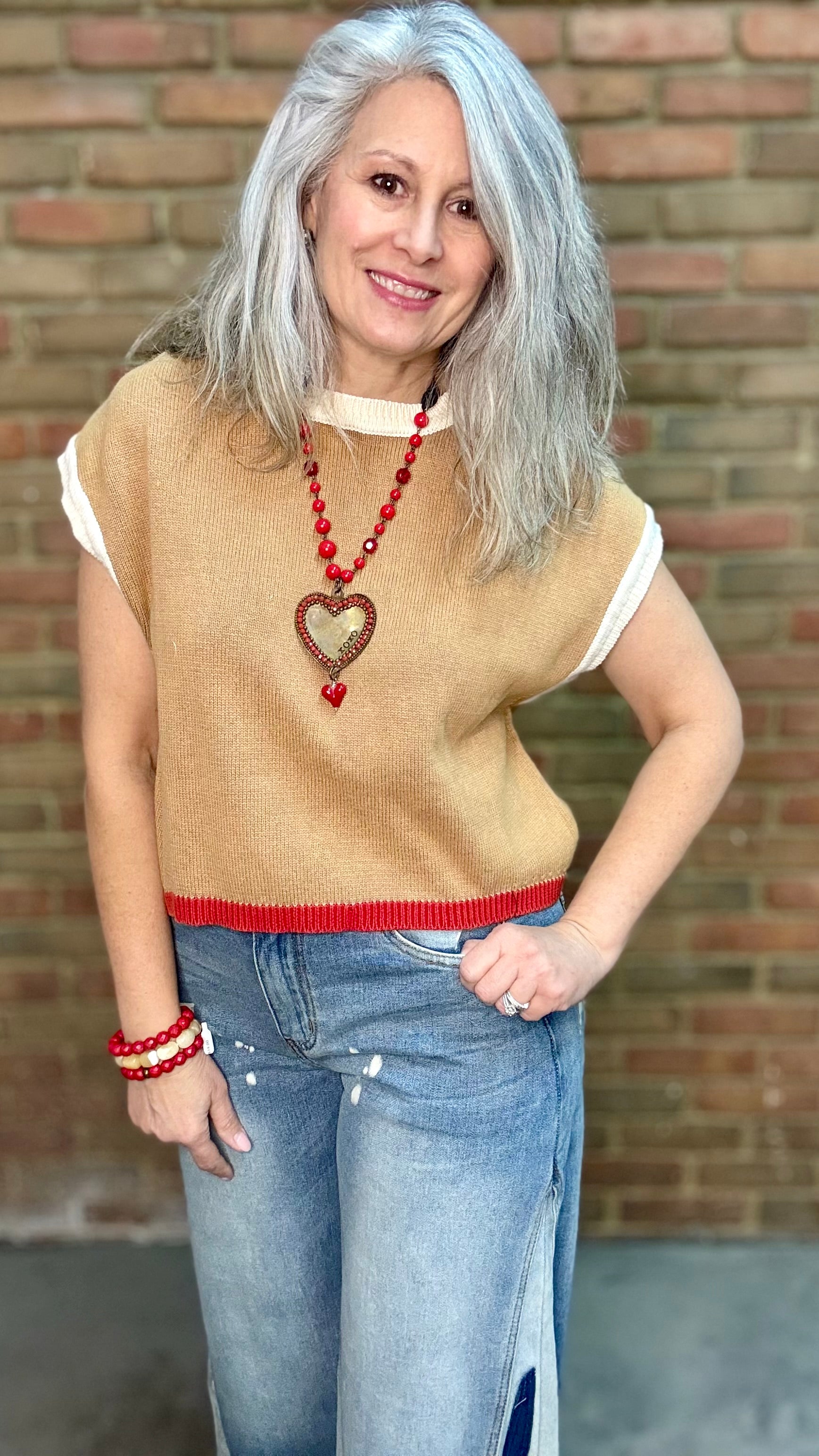 Woman wearing Chestnut Flame Sweater paired with Bleached Wide Leg Jeans and Heads Up - Red Shoes styled with XOXO heart on Red Bead Necklace