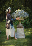 Side view of The Dreamer Kimono, model is standing in a garden.