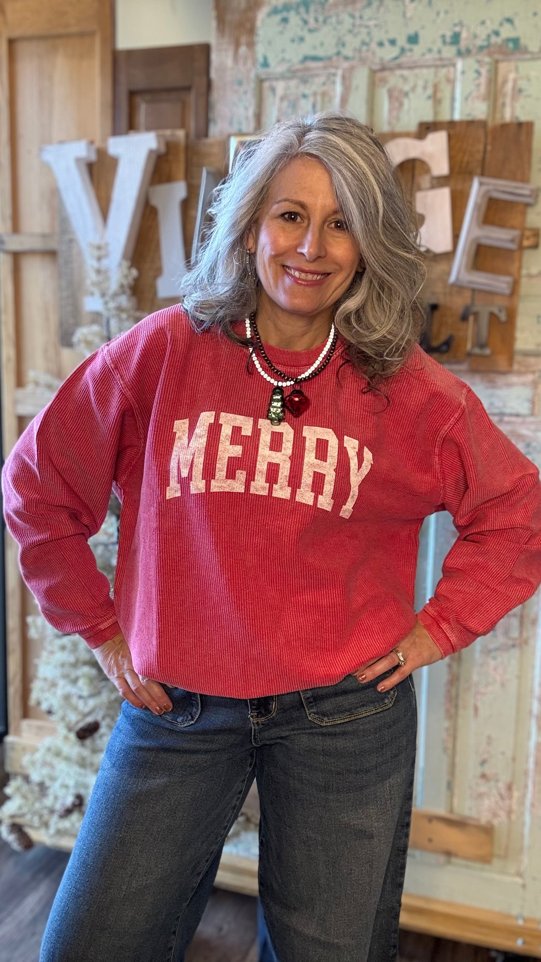 Woman wearing a red sweatshirt with &