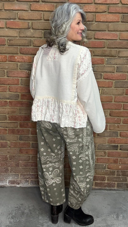 Woman wearing the Natural Flare Sleeve Mix Media Top and Paisley Print Barrel Jean standing against a brick wall.