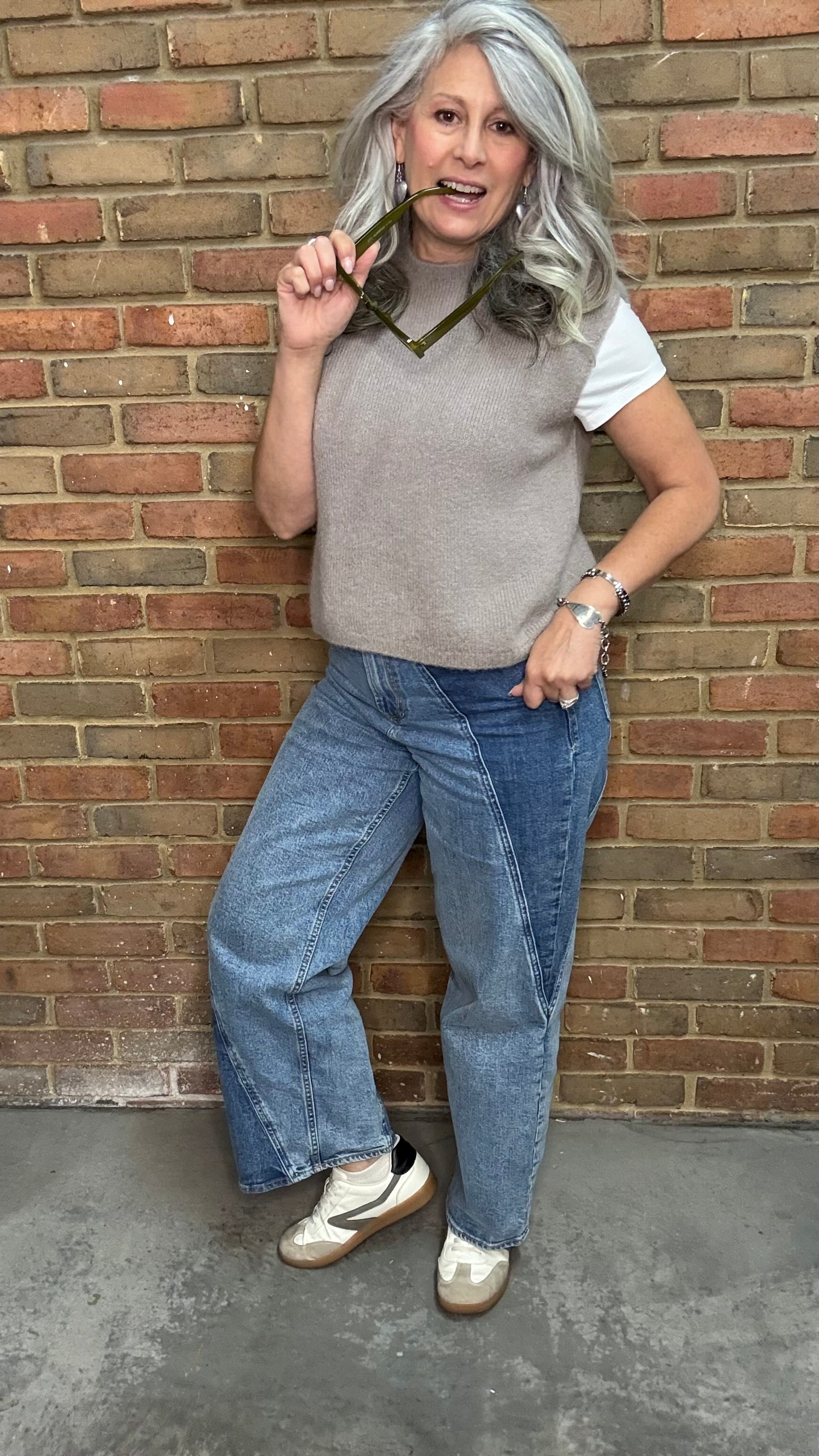Woman in the HOLLY Super High Rise Two Tone Straight Jean casual outfit standing against a brick wall