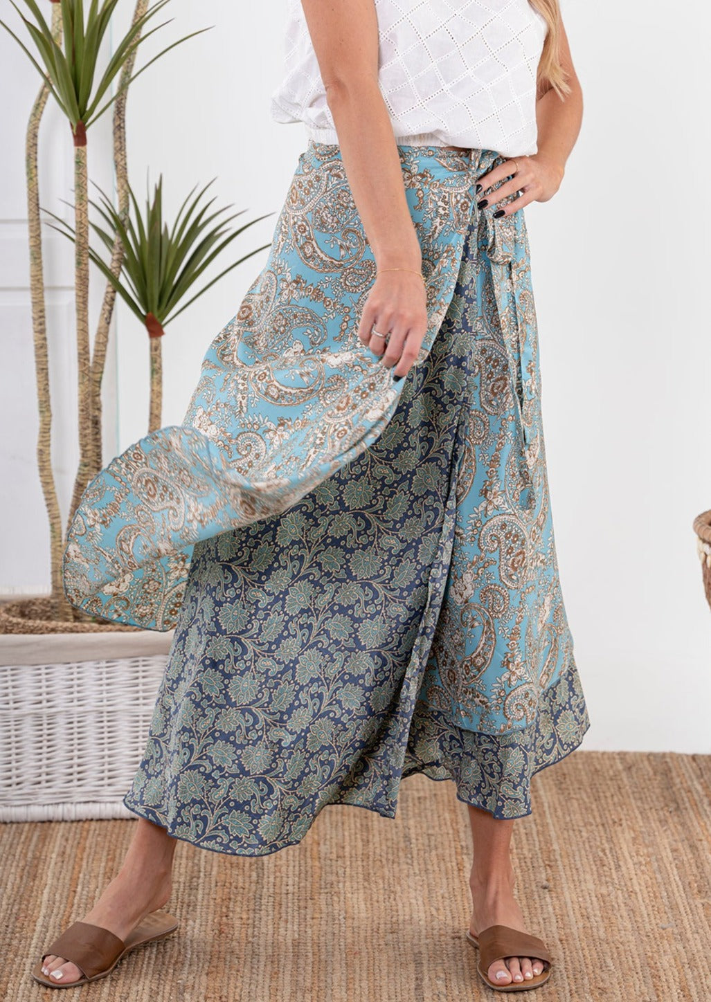 Model wearing Kali Wrap Skirt, swirling one layer of the skirt.