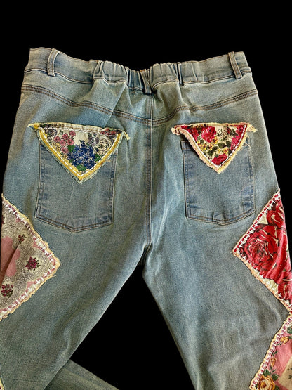Denim jeans with floral patchwork on a black background