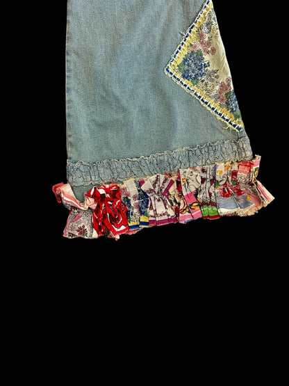 Denim pant with colorful ruffled hem on a black background
