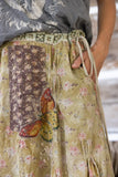 close up view of butterfly applique on front of Reza Skirt.