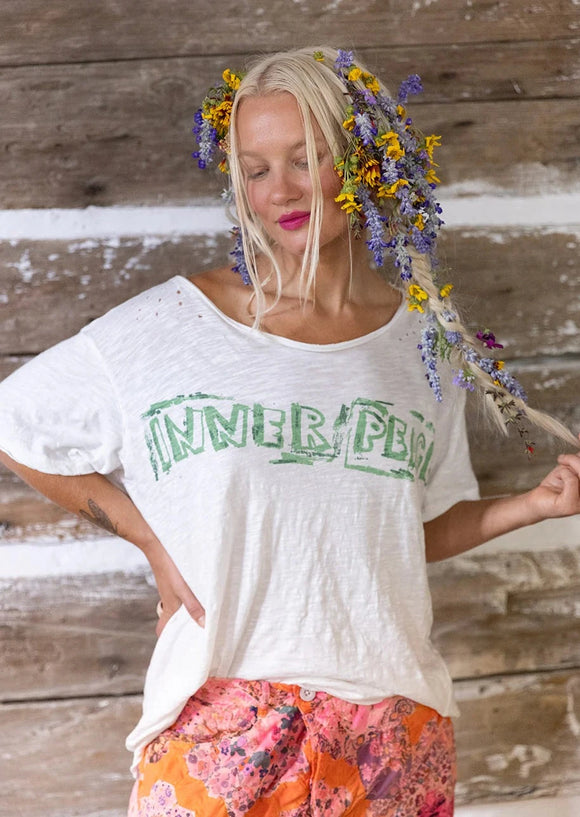 Front view of model wearing Inner Peace T shirt.  Graphic reads 