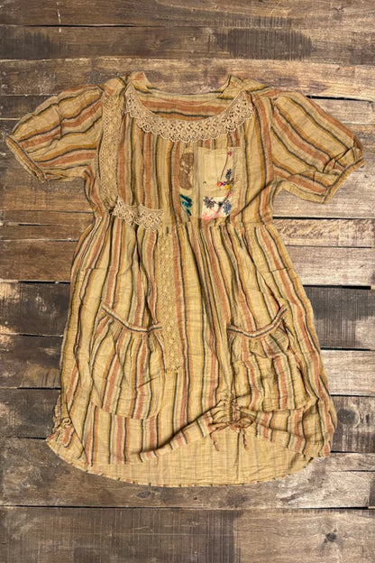 Vintage dress with intricate patterns on a wooden background