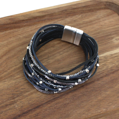 Multistrand bracelet with beads on a wooden surface