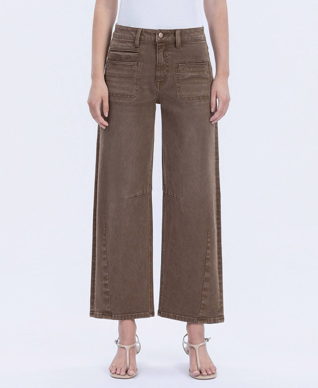 Brown wide-leg jeans worn by a person on a white background