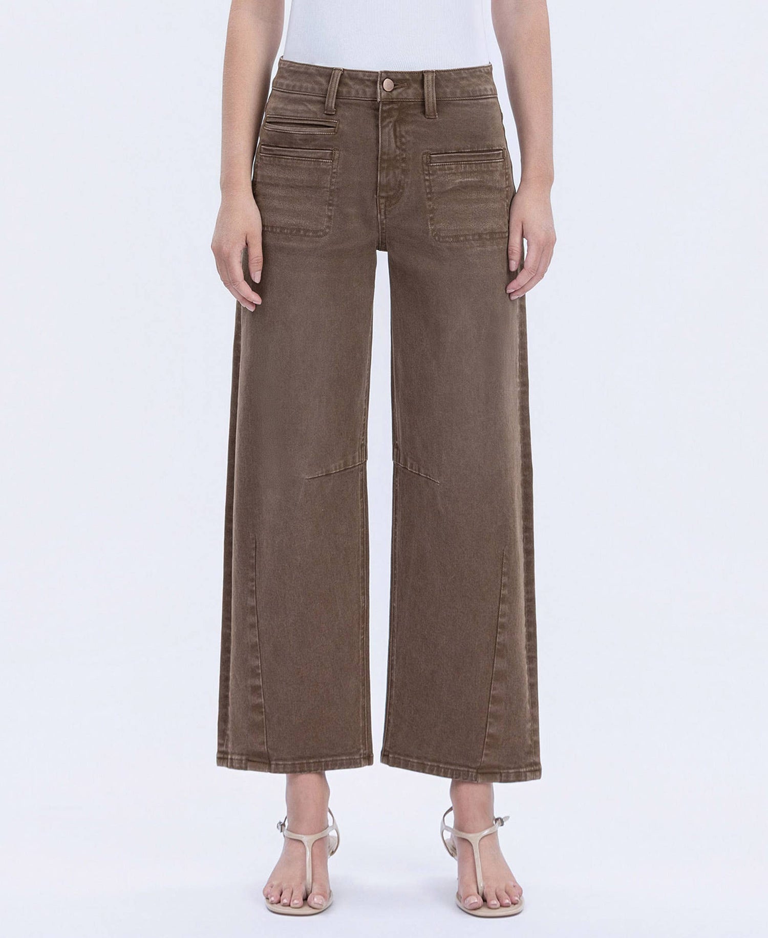 Brown wide-leg jeans worn by a person on a white background