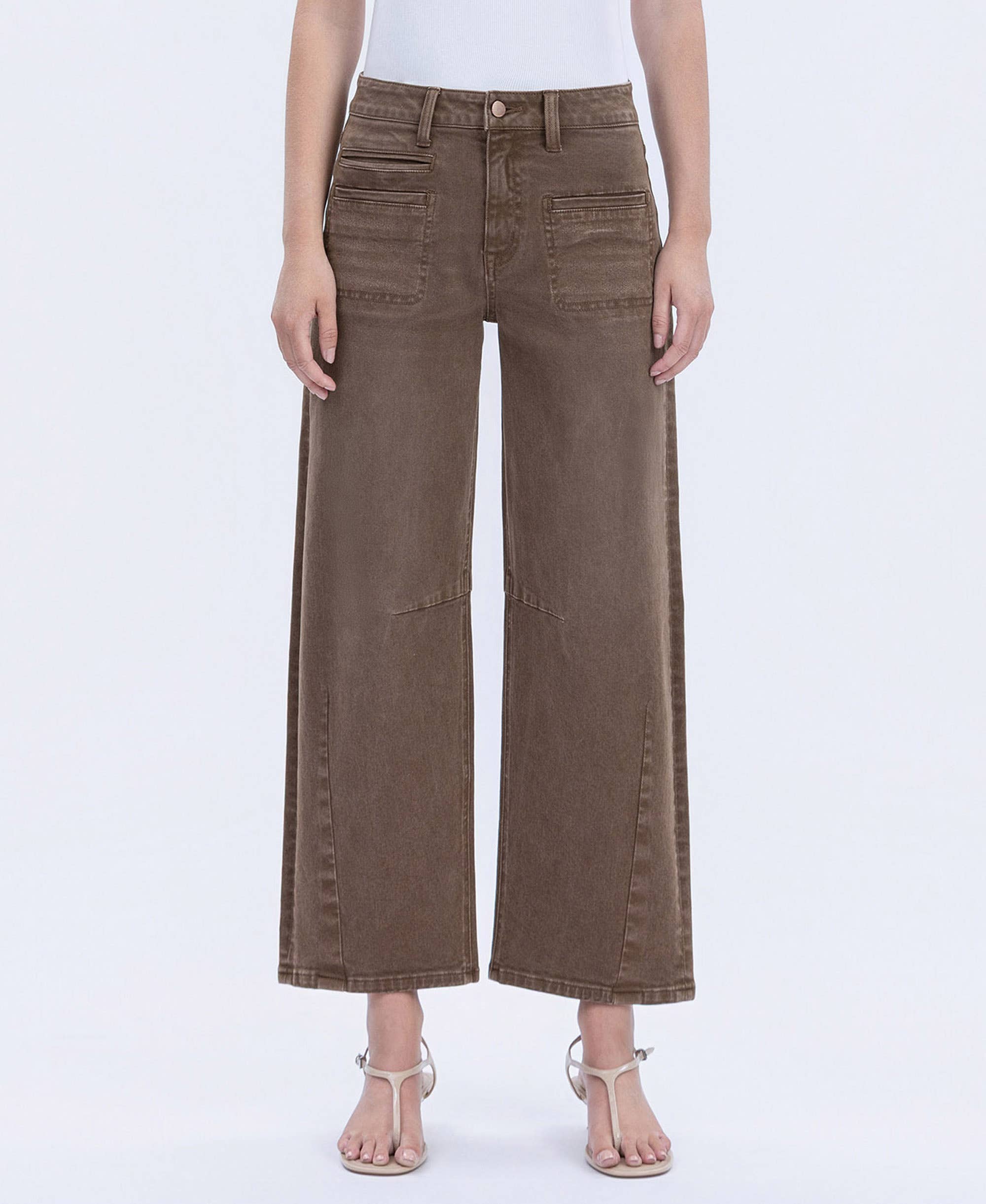 Brown wide-leg jeans worn by a person on a white background