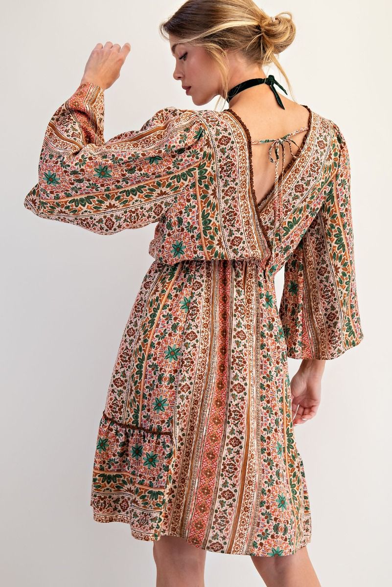 Woman wearing a patterned dress with a white background
