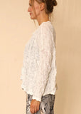 Side view of Sydney Jacket/Top on a model, shown in white.